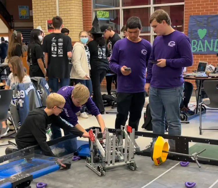 Chase working with robot teams from Granbury High School